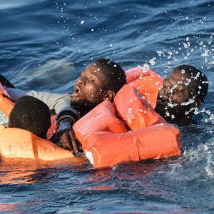 People struggle in the water during a rescue operation of a rescue ship run by Maltese NGO Moas and the Italian Red Cross off the Libyan coast.